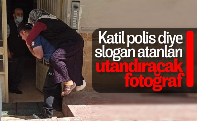 Ayağı kırılan kadını sırtında taşıyan polis